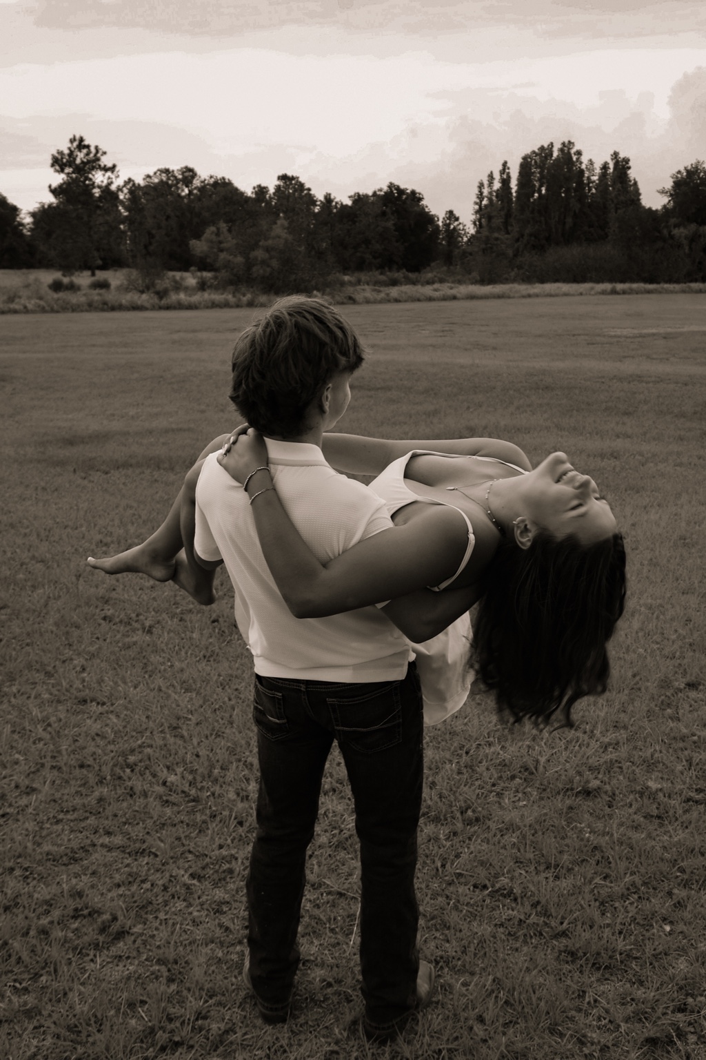 Couple sharing a playful moment in a field