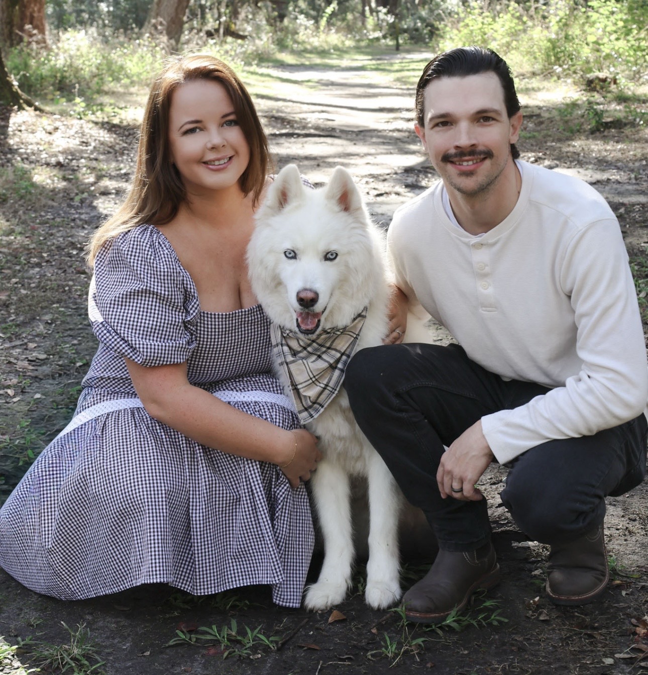 Couple with their dog on a woodland path
